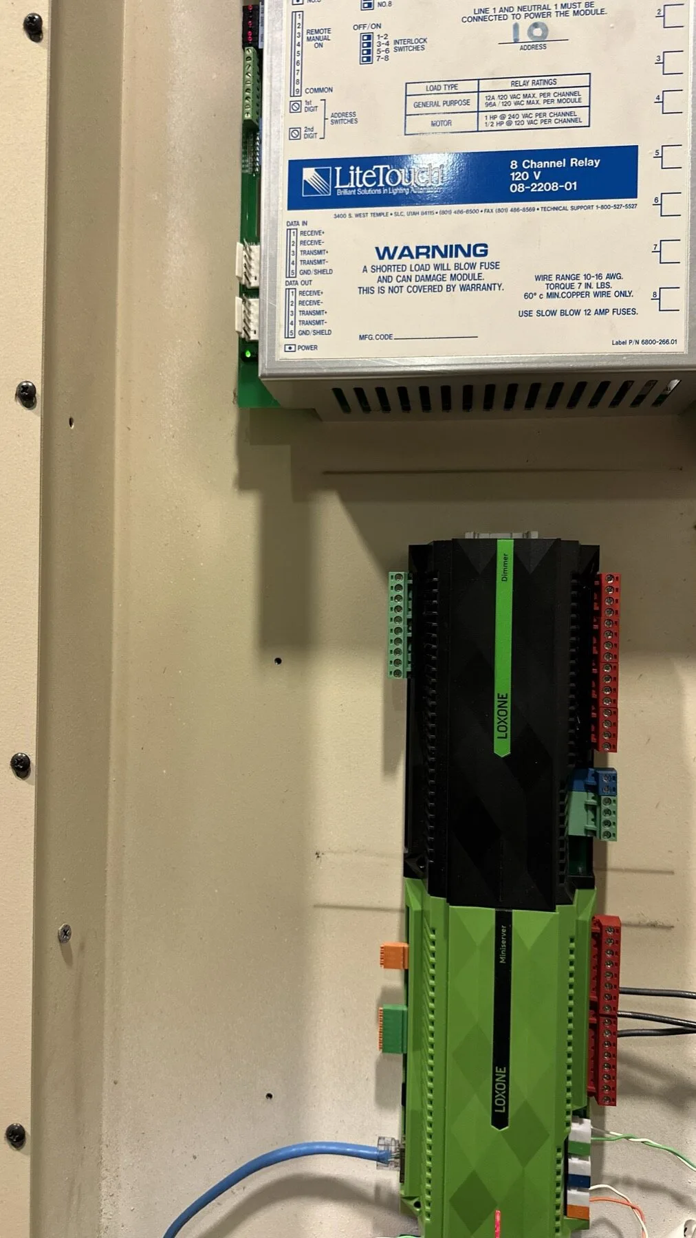 A LiteTouch relay module above a LOXONE extension in the same panel