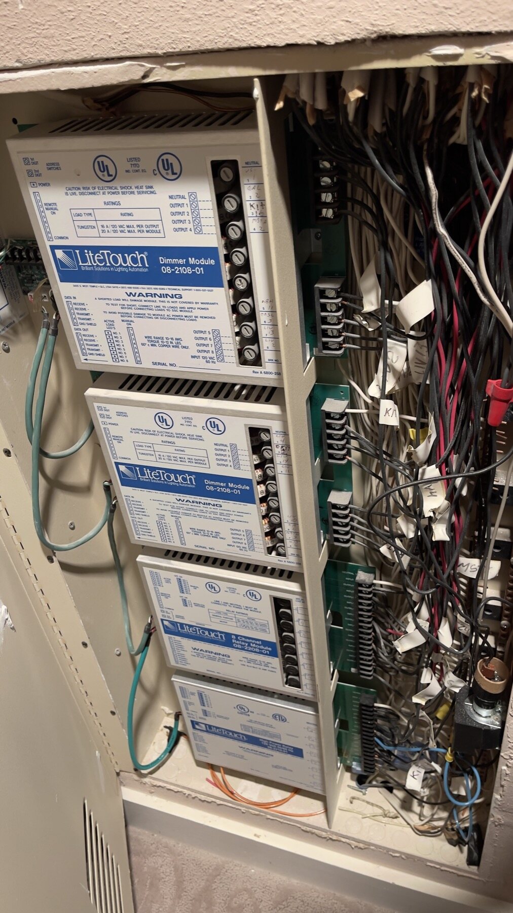 A LiteTouch enclosure containing an 08-2108-01 Dimmer Module, an 08-2206-01 8 Channel Relay Module and a Savant-branded module installed in the same rack