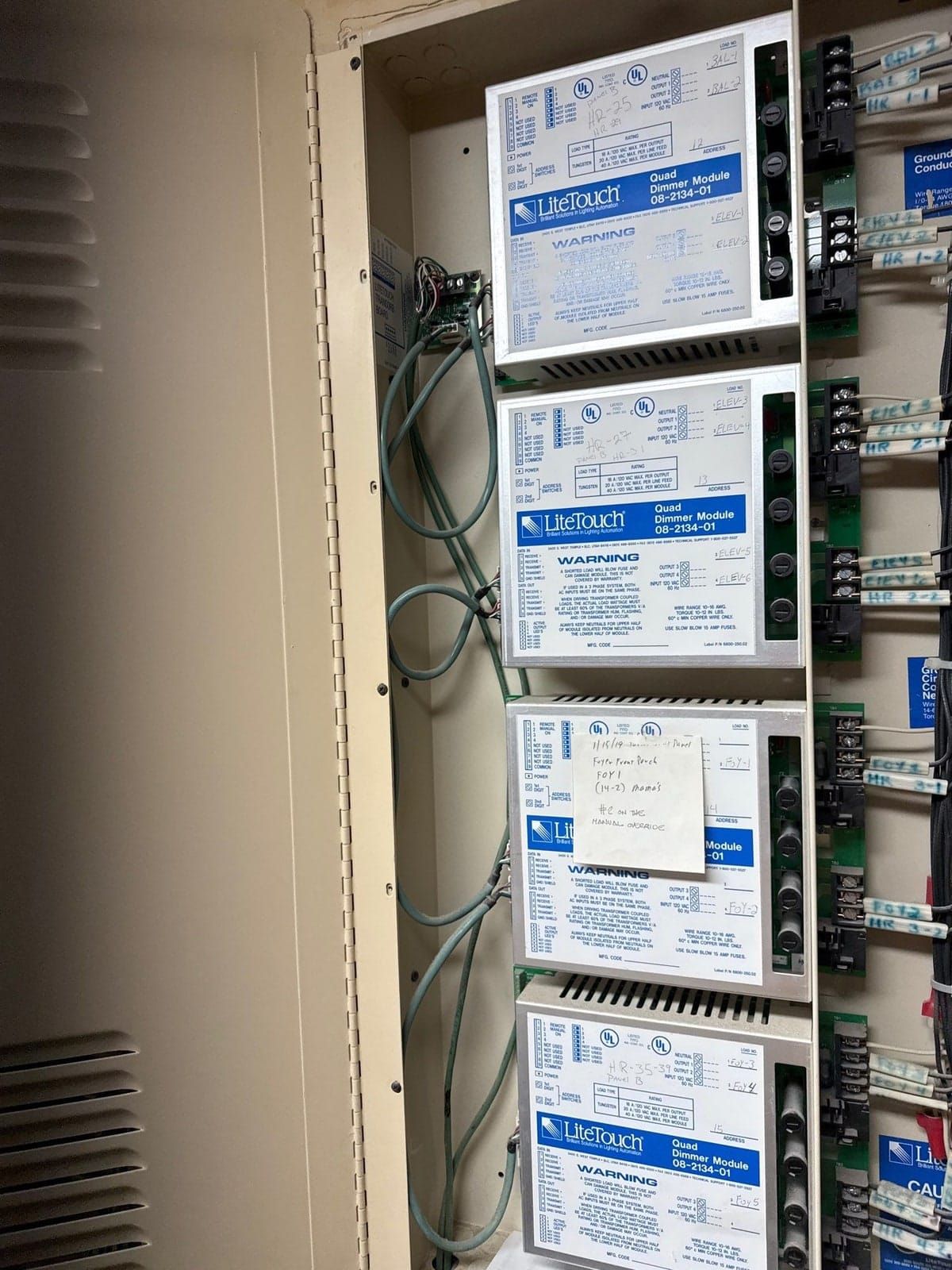 Legacy LiteTouch lighting control panel in a Houston home's mechanical room — central processor and dimming modules