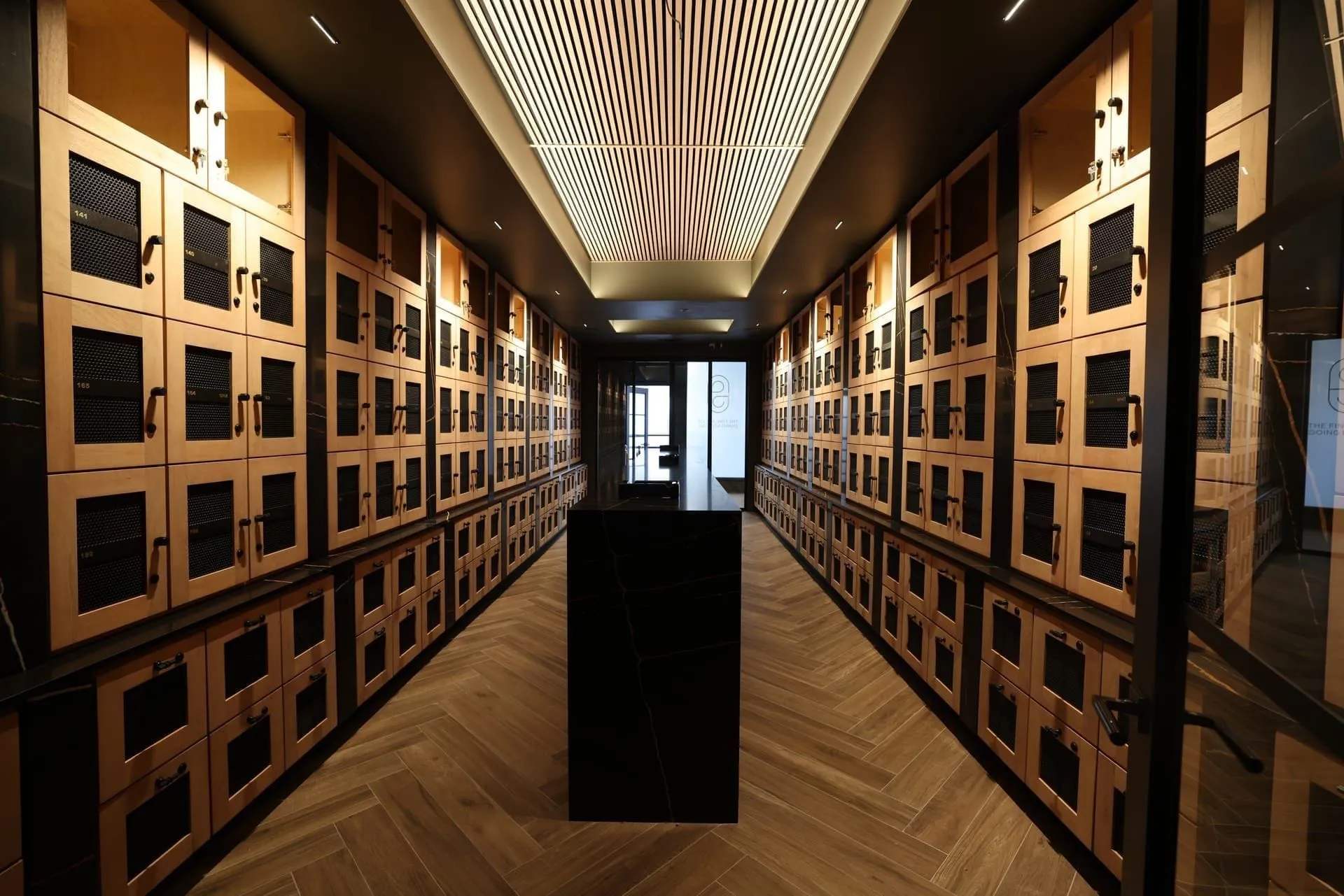 Stoa Fine Cigars — humidor cabinet lit by warm-white Loxone RGBW